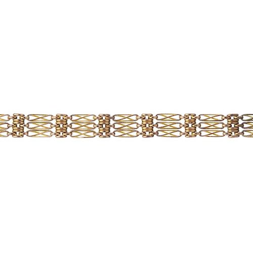 An early 20th century 9ct gold bracelet. Designed as a series of fancy gate-links and brick-links, t