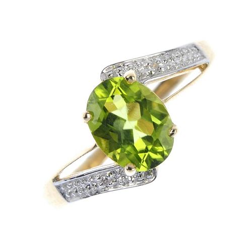 A 9ct gold peridot and diamond crossover ring. The oval-shape peridot, to the single-cut diamond asy