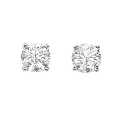 A pair of 18ct gold brilliant-cut diamond single-stone ear studs. Total diamond weight 0.66ct,stampe