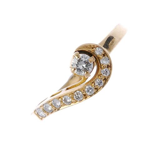 A 14ct gold diamond twist ring. The brilliant-cut diamond, to the graduated brilliant-cut diamond cu