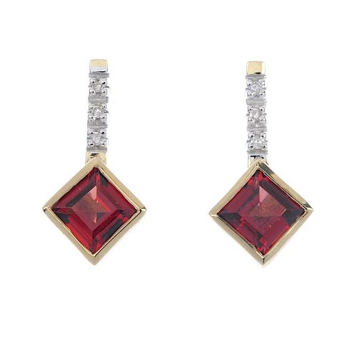A pair of garnet and diamond ear pendants. Each designed as a kite-shaped garnet, suspended from sin