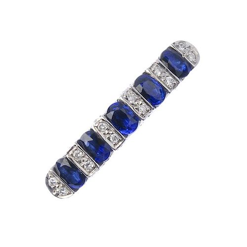An 18ct gold sapphire and diamond ring. The oval-shape sapphires, with brilliant-cut diamond spacers