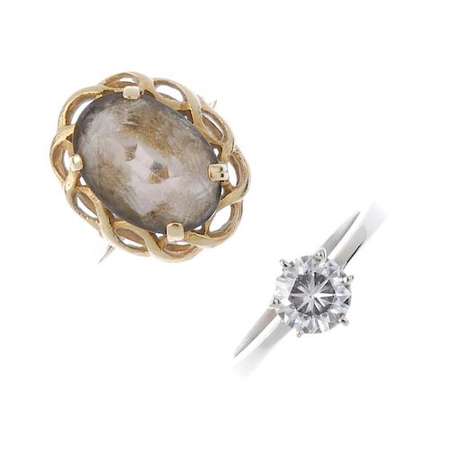 Two gem-set rings. To include, a 9ct gold oval-shape Smokey quartz ring within an openwork surround,