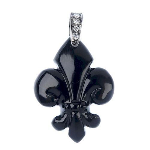 A onyx and diamond pendant. The carved onyx fleur-de-lys, to the brilliant-cut diamond tapered surmo