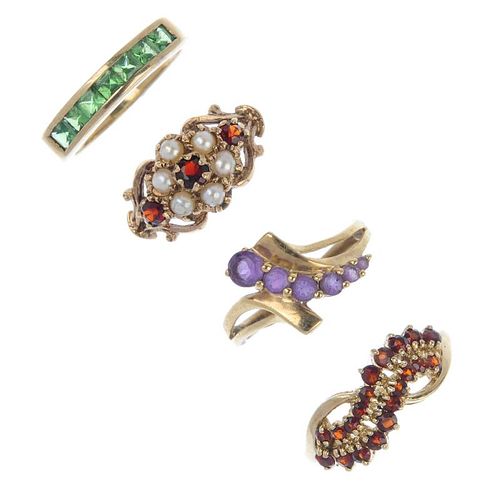 Four 9ct gold gem-set rings. To include a circular-shape amethyst crossover dress ring, a circular-s