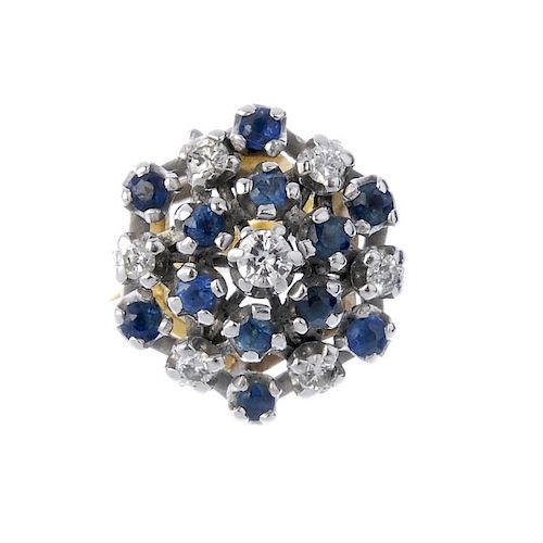 An 18ct gold sapphire and diamond cluster ring. Of openwork design, the brilliant-cut diamond, withi