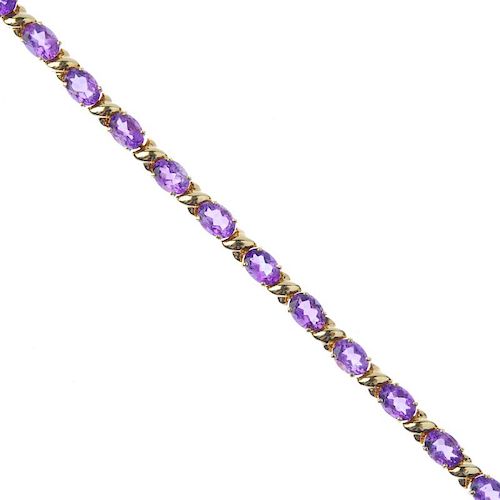 An amethyst bracelet. Designed as a series of oval-shape amethyst, with cross spacers, to the push-p