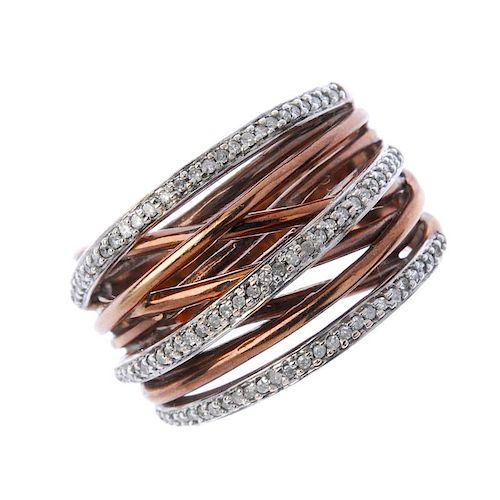 A 9ct gold diamond dress ring. Designed as a series of interwoven bands, with single-cut diamond ove