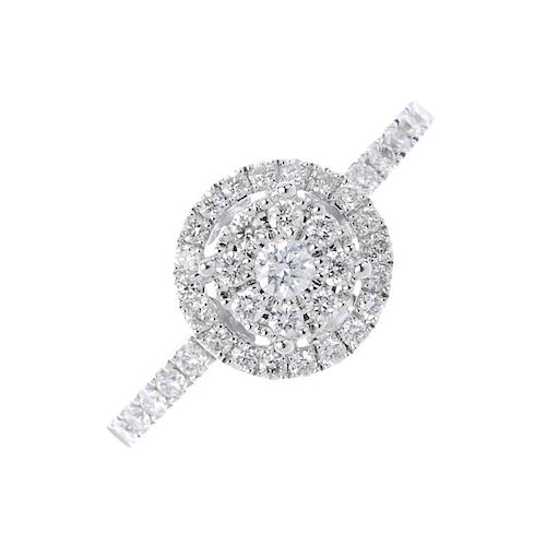 A diamond cluster ring. The brilliant-cut diamond cluster, with similarly-cut diamond halo and sides