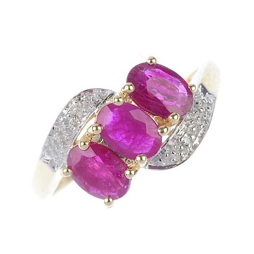 A 9ct gold ruby and diamond dress ring. The oval-shape ruby diagonal line, with illusion-set diamond