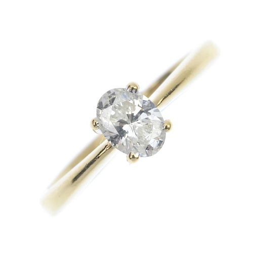 An 18ct gold diamond single-stone ring. The oval-shape diamond, to the tapered shoulders and plain b