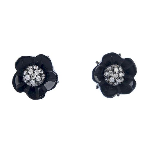 A pair of onyx and diamond floral ear studs. Each designed as a brilliant-cut diamond cluster, with