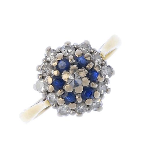 A sapphire and diamond cluster ring. The single-cut diamond and circular-shape sapphire tiered clust