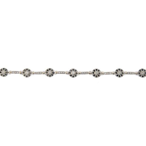 A diamond and gem-set bracelet. Designed as a series of brilliant-cut diamond and circular-shape bla