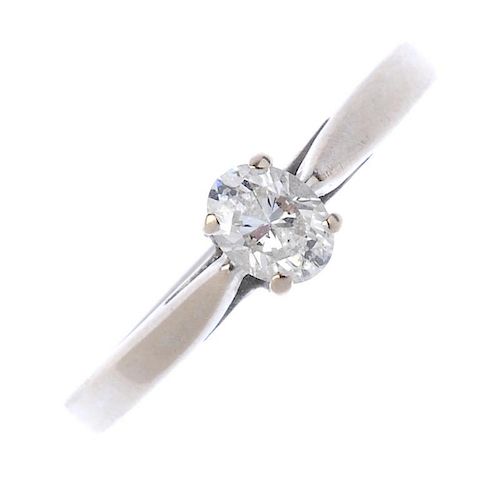 An 18ct gold diamond single-stone ring. The oval-shape diamond, to the tapered band. Estimated diamo
