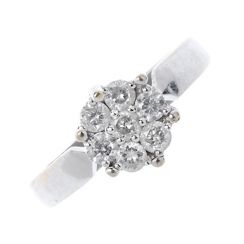 An 18ct gold diamond cluster ring. The brilliant-cut diamond cluster, to the plain band. Estimated d