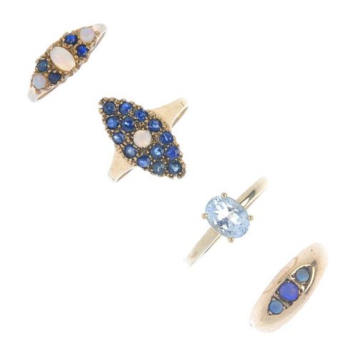 Four 9ct gold gem-set rings. To include an Edwardian opal three-stone band ring, an opal and sapphir