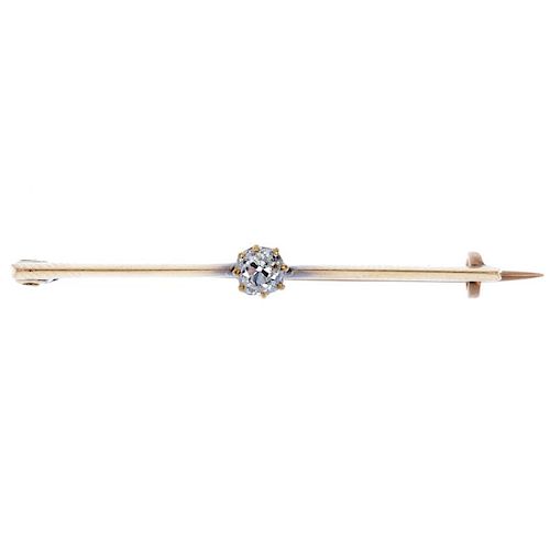 A late 19th century gold diamond single-stone bar brooch. The old-cut diamond, to the knife-edge bar