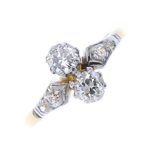 A diamond two-stone ring. The brilliant-cut diamonds, to the old-cut diamond shoulders and plain ban