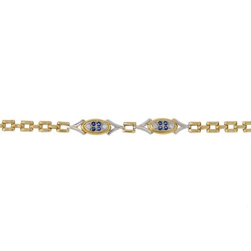 A sapphire and diamond bracelet. Of bi colour design, the circular-shape sapphire and brilliant-cut