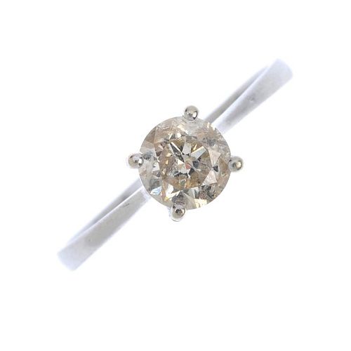 A diamond single-stone ring. The brilliant-cut diamond, to the tapered shoulders and plain band. Est