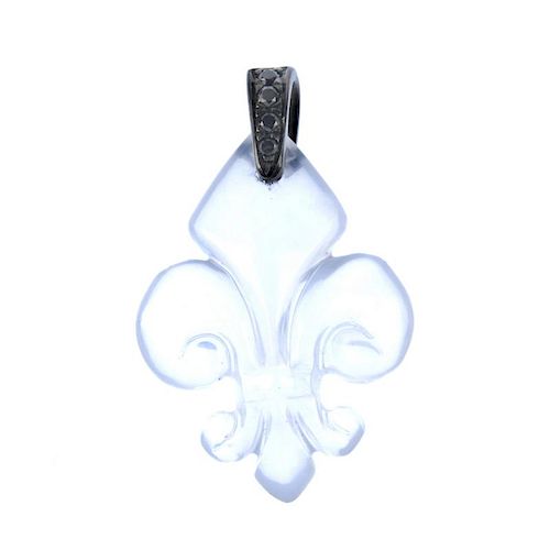 A chalcedony and gem-set pendant. The carved chalcedony fleur-de-lys, to the circular-shape black-ge