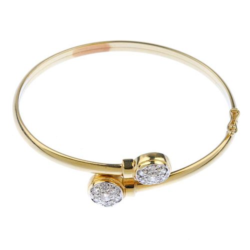 Two bangles. To include a crossover bangle with cubic zirconia cluster terminals, together with a bi