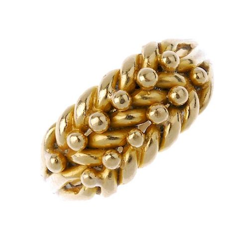 An 18ct gold keeper ring. The woven panel, with bead spacers, to the grooved band. Hallmarks for Bir