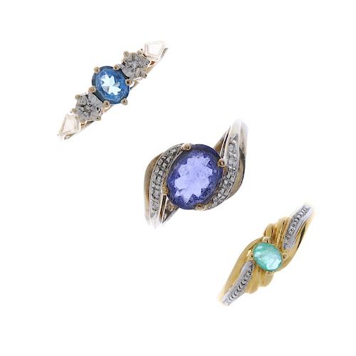 A selection of three gem-set rings. To include an emerald single-stone ring, an iolite and diamond c