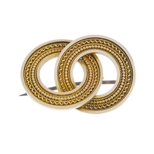 A late 19th century gold brooch. Designed as two cannetille, linked hoops. Length 3.1cms. Weight 6.9