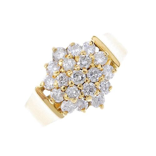 An 18ct gold diamond cluster ring. The brilliant-cut diamond stepped cluster, to the plain band. Est