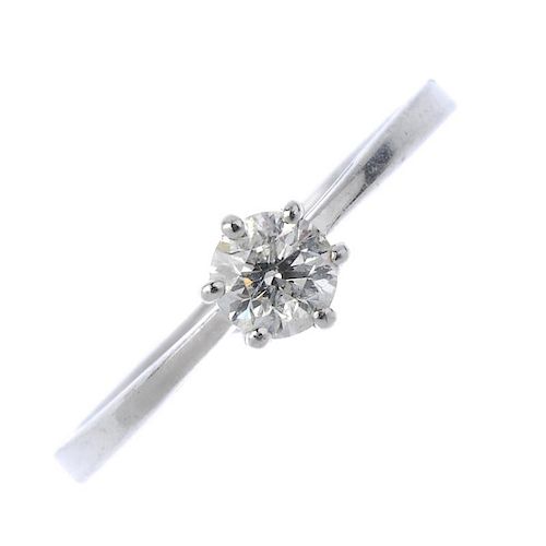 A platinum diamond single-stone ring. the brilliant-cut diamond, to the tapered shoulders and plain