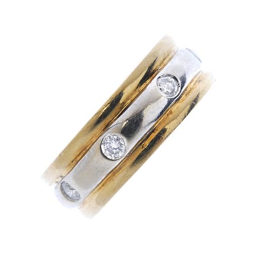 A 9ct gold diamond band ring. Designed as a series of brilliant-cut diamonds, spaced to the bi-colou