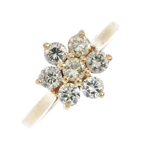 A 14ct gold diamond floral cluster ring. The brilliant-cut diamond, within a similarly-cut diamond s
