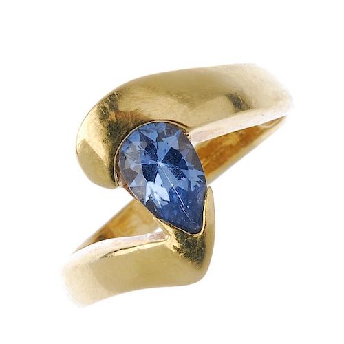 A synthetic spinel crossover ring. The pear-shape blue synthetic spinel, to the asymmetric shoulders