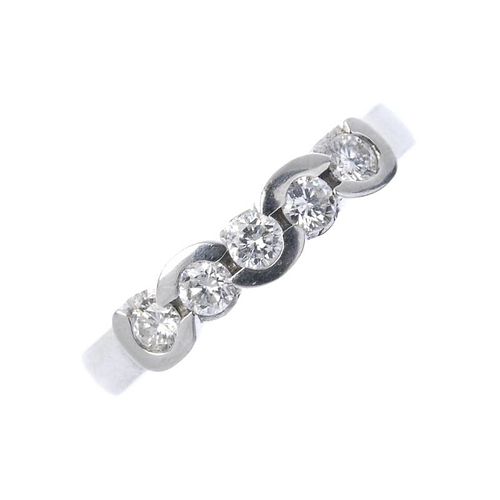 A platinum diamond five-stone ring. The brilliant-cut diamond line, with alternating partial collet