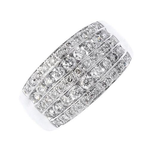 An 18ct gold diamond dress ring. The brilliant-cut diamond channel-set lines, with pave-set diamond
