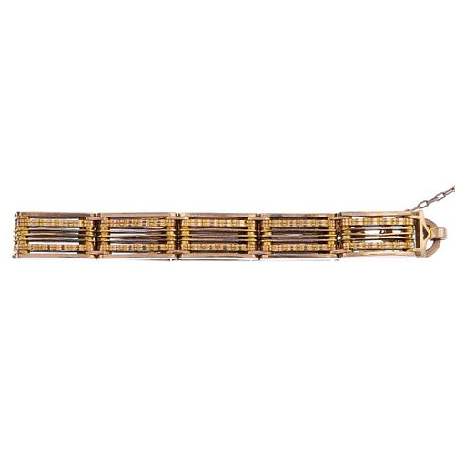 An early 20th century 9ct gold gate bracelet. Designed as a series of gate-links, with textured bar