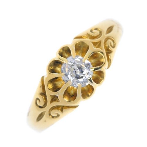 An 18ct gold diamond single-stone ring. The old-cut diamond, to the scrolling sides and replacement