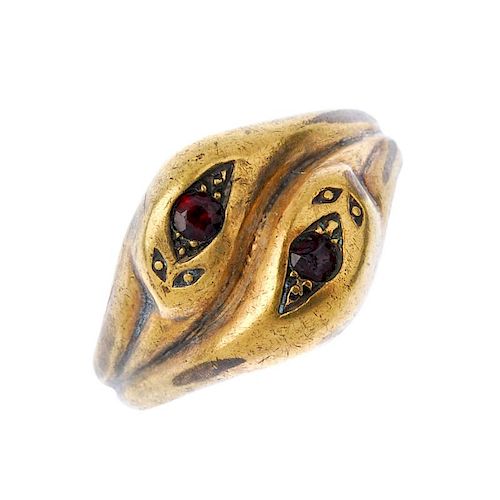 A gentleman's 1970s 9ct gold paste snake ring. The circular-shape red paste snakes heads, to the rid