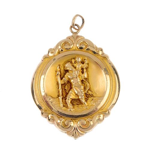 A 9ct gold embossed pendant. The vintage car and Saint Christopher reverse, within a scroll border.