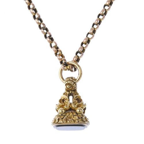 A late Victorian gold hardstone fob and later chain. The cushion-shape hardstone, to the scroll and