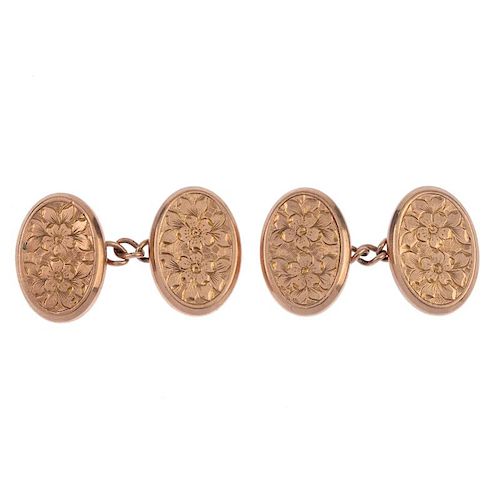 Two pairs of early 20th century 9ct gold cufflinks. Each designed as two oval-shape foliate engraved
