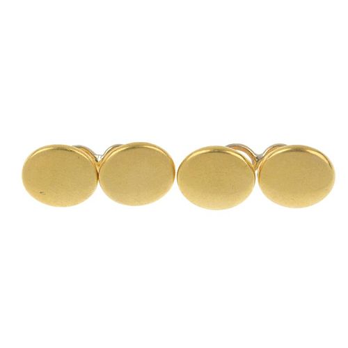 A pair of early 20th century 18ct gold cufflinks. Each designed as a circular-shape disc, to the sim
