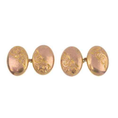 Two pairs of 9ct gold cufflinks. To include a pair of early 20th century 9ct gold oval-shape scroll