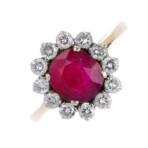 (536613-2-A) A glass-filled ruby and diamond cluster ring. The cushion-shape glass-filled ruby, with