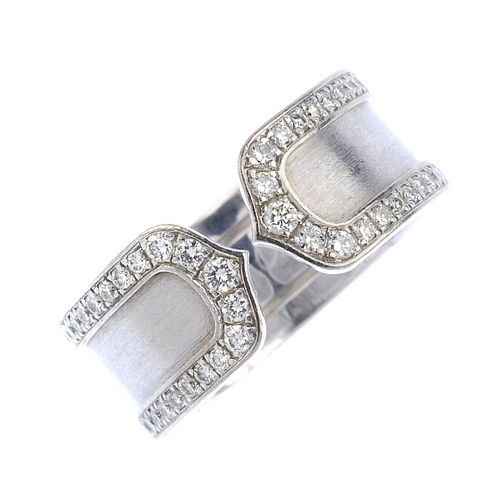 (539290-1-A) CARTIER - a 'C de Cartier' diamond ring. The textured torque band, with brilliant-cut d