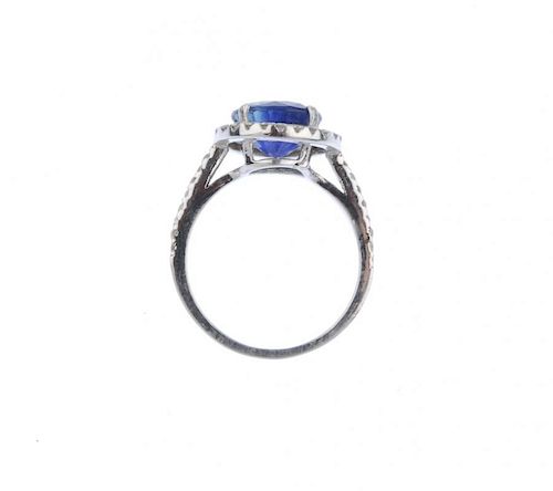 (539356-2-A) A sapphire and diamond cluster ring. The circular-shape sapphire, with brilliant-cut di