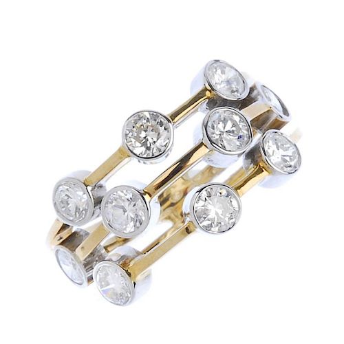 (540912-1-A) A diamond dress ring. Designed as a series of brilliant-cut diamond collets, scattered