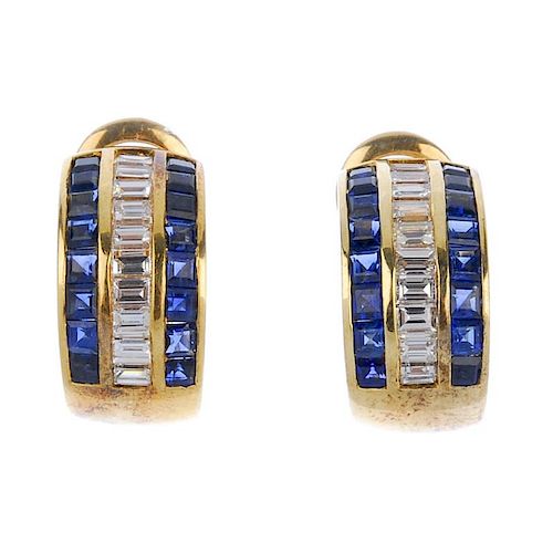 (541052-2-A) A pair of diamond and sapphire ear clips. Each designed as a baguette-cut diamond line,